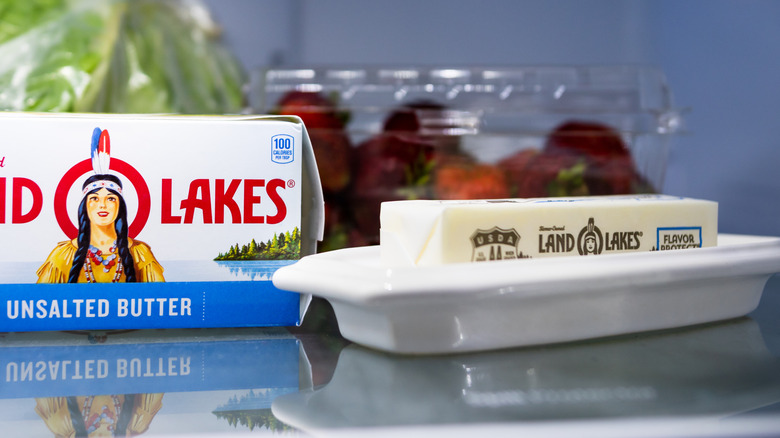 Wrapped stick of butter in butter dish next to Land O Lakes butter box