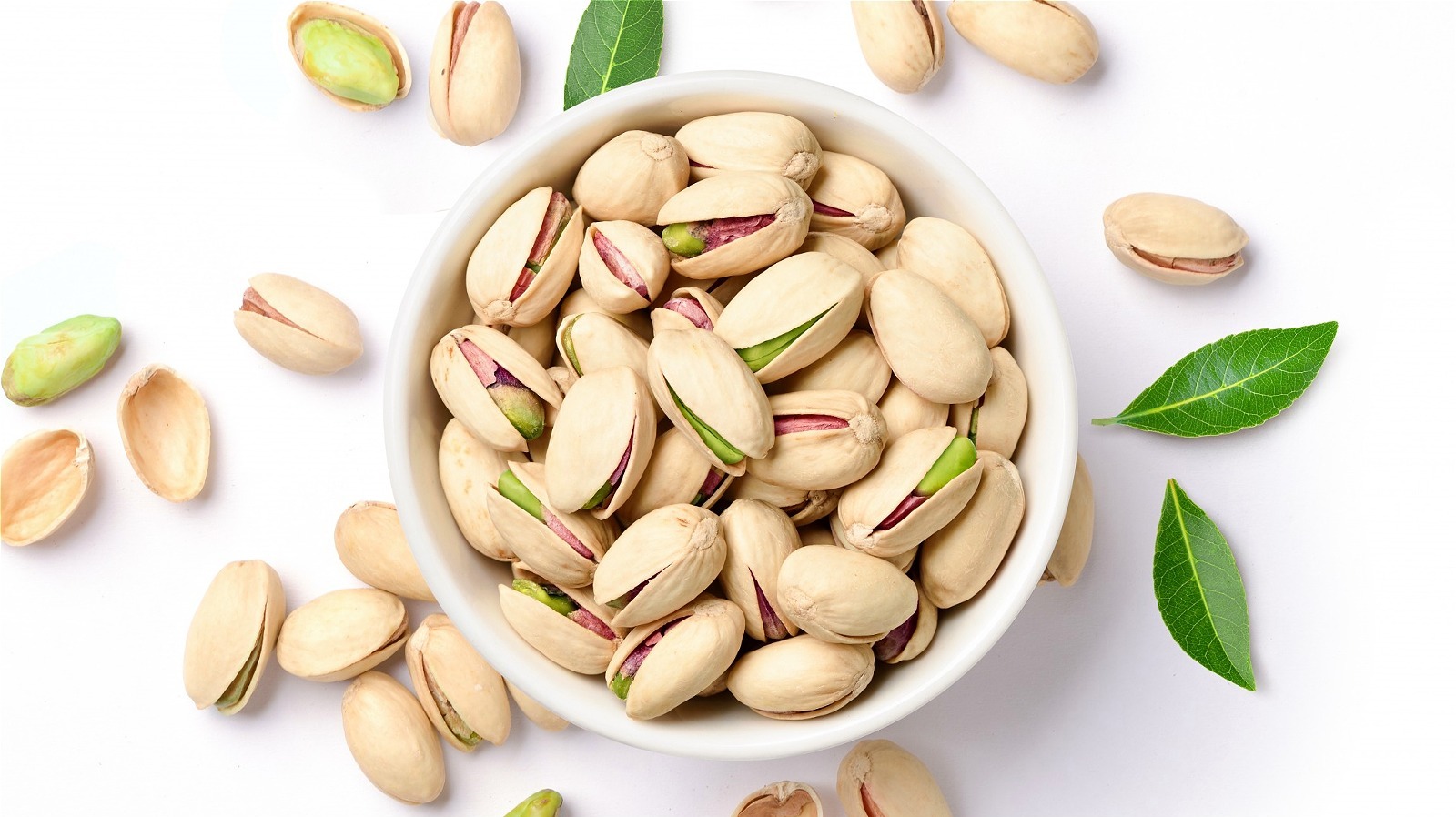 https://www.thedailymeal.com/img/gallery/why-pistachios-are-often-sold-in-their-shells/l-intro-1667403337.jpg