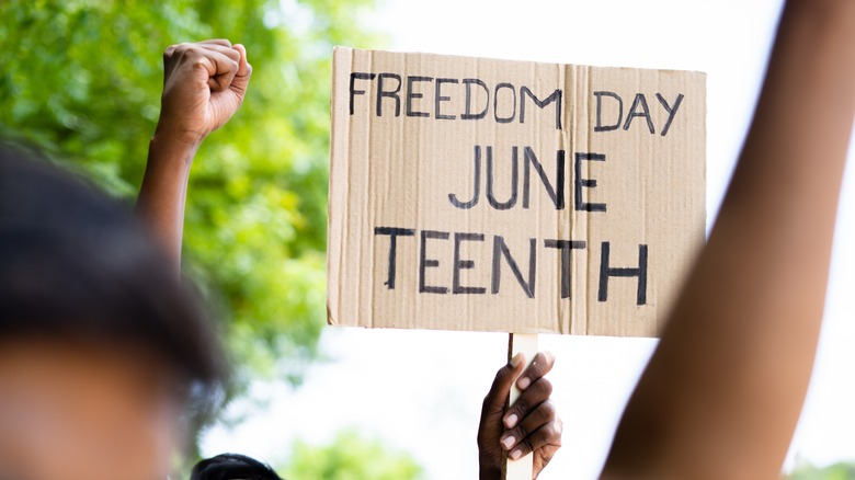 Person holding Juneteenth placard