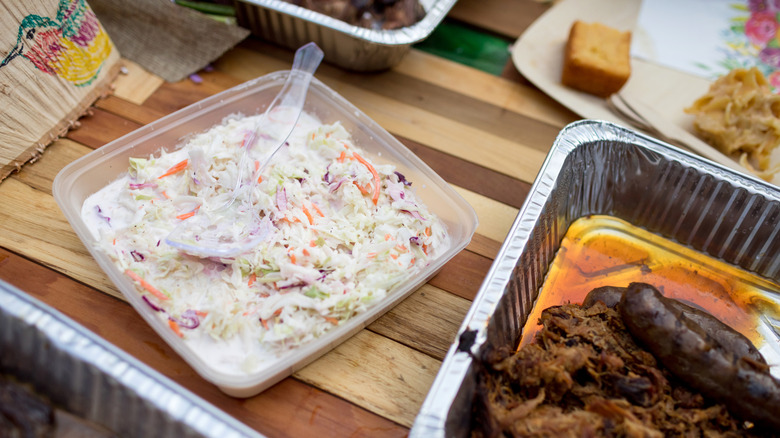 Coleslaw in a tray sitting out at a barbecue