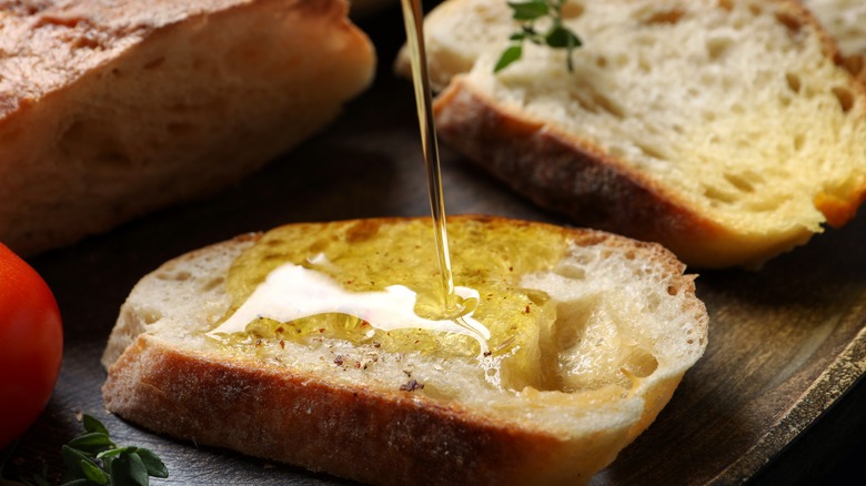 Olive oil being drizzled on bread
