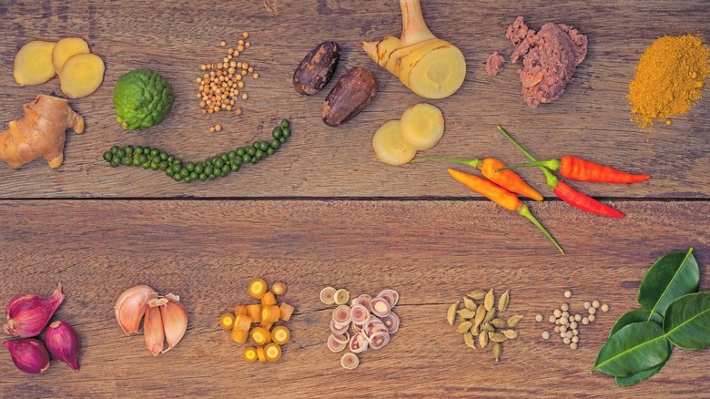 Thai curry ingredients on wooden surface