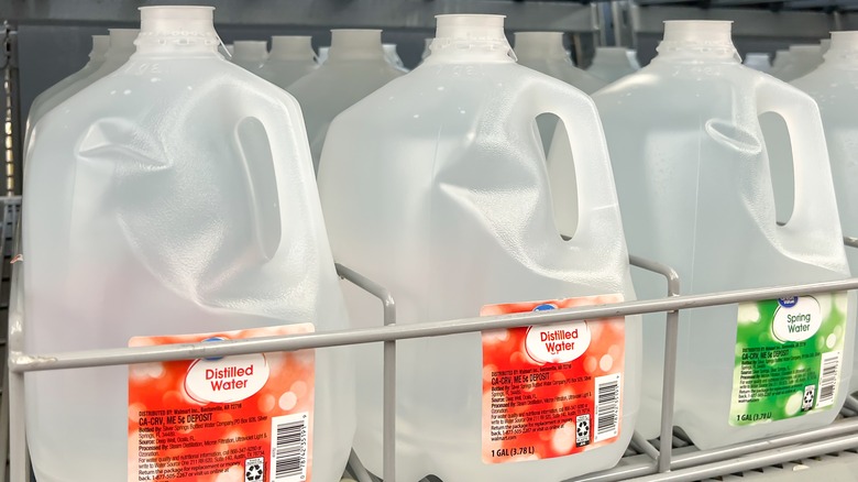 shelf of distilled water jugs