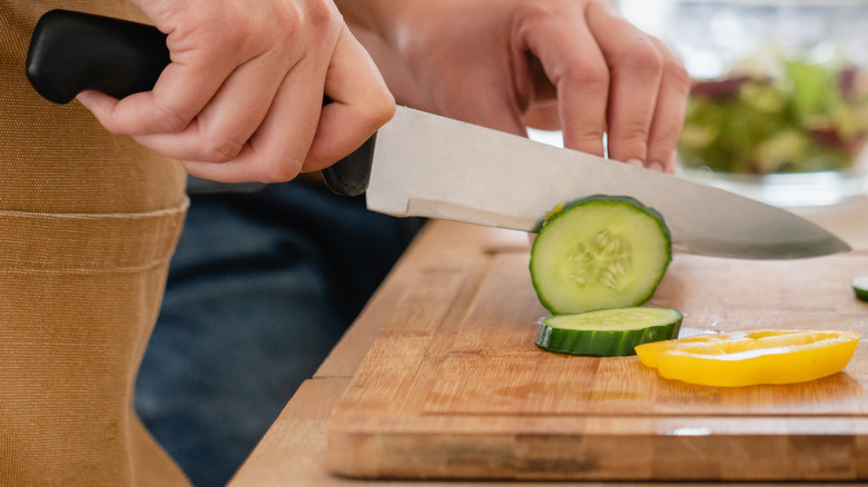 wooden cutting board chopped cucumber