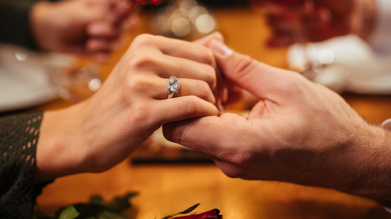 hands held at restaurant