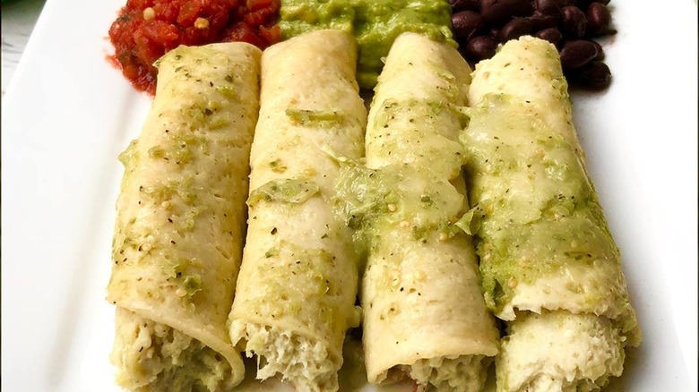 Realgood chicken enchiladas on plate with condiments