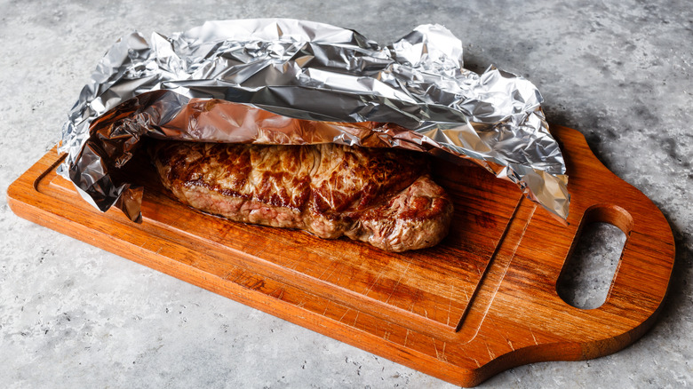 steak resting on a wooden board