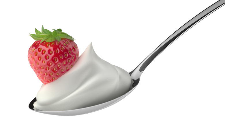 Strawberry on silver spoon with Cool Whip