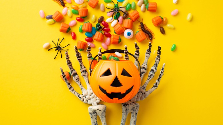 skeleton hands with trick-or-treat basket