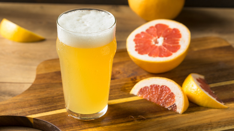 Grapefruit and frothy beer glass