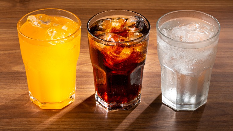 Three glasses of different soda flavors
