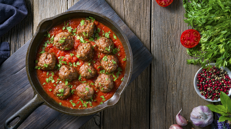 meatballs and sauce in cast iron pan