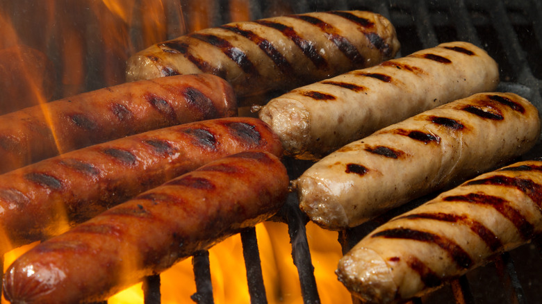 Chicken and beef hot dogs on grill