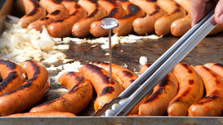 Hot dogs on grill with thermometer