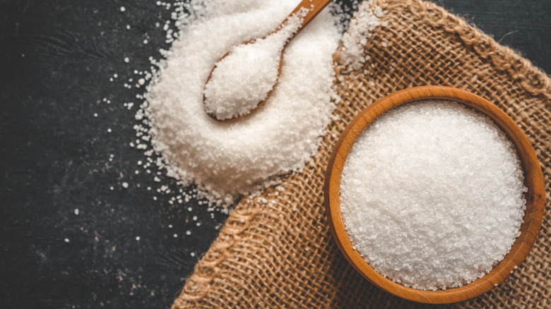 salt in a bowl, and on a gray counter with a spoon
