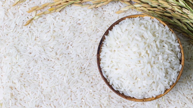bowl of rice grains on a bed of rice grains