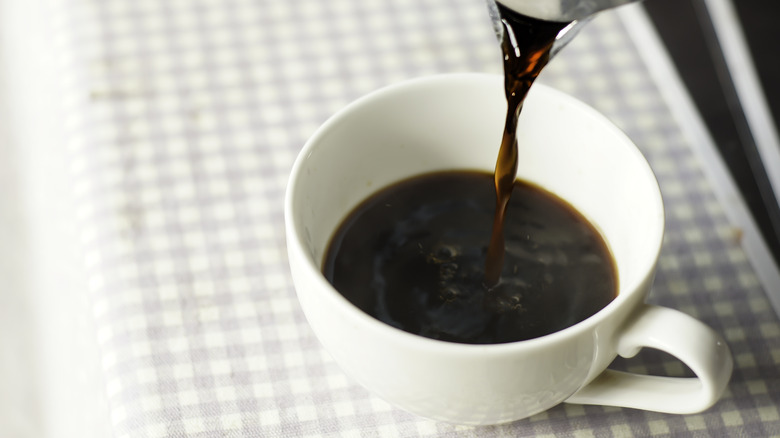 coffee being poured into cup