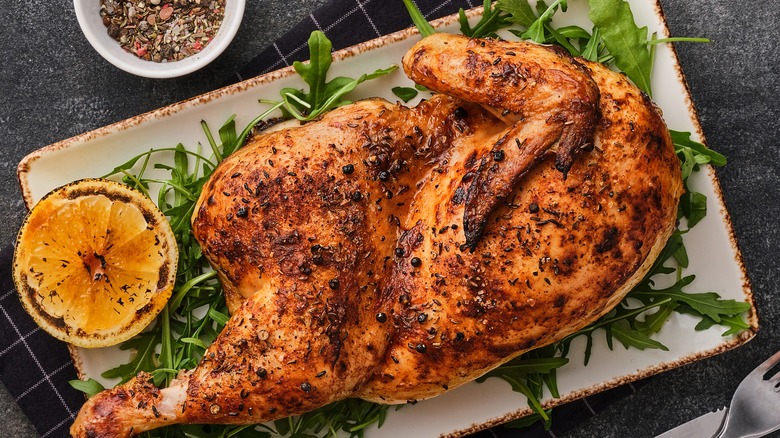 roast chicken on bed of arugala