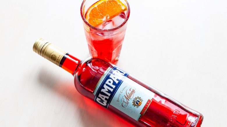 Campari bottle with a glass and orange slice