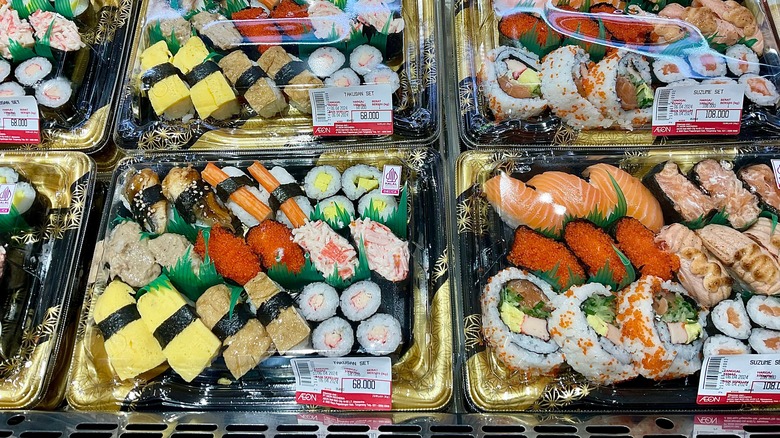 large platters of supermarket sushi