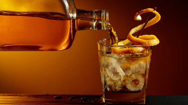 Whiskey or bourbon pouring into a glass.