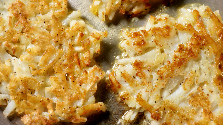 seasoned hashbrowns frying in a pan