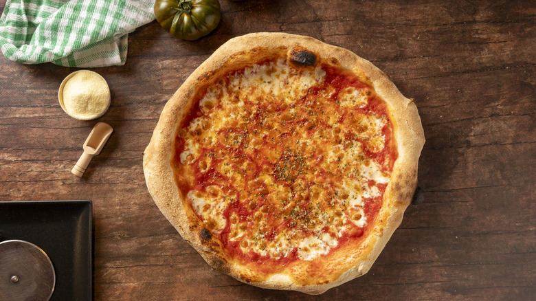 Homemade pizza with Parmesan and herbs