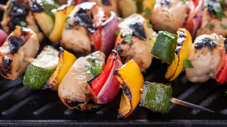 Grilling meat and vegetable kebabs