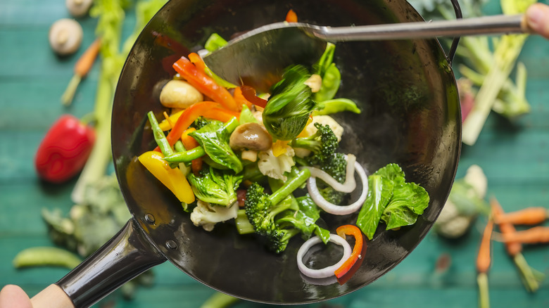 Sautéing vegetables in wok