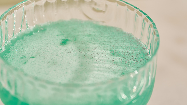 glitter on top of green cocktail
