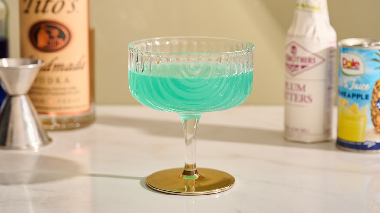 Strained green cocktail on a table