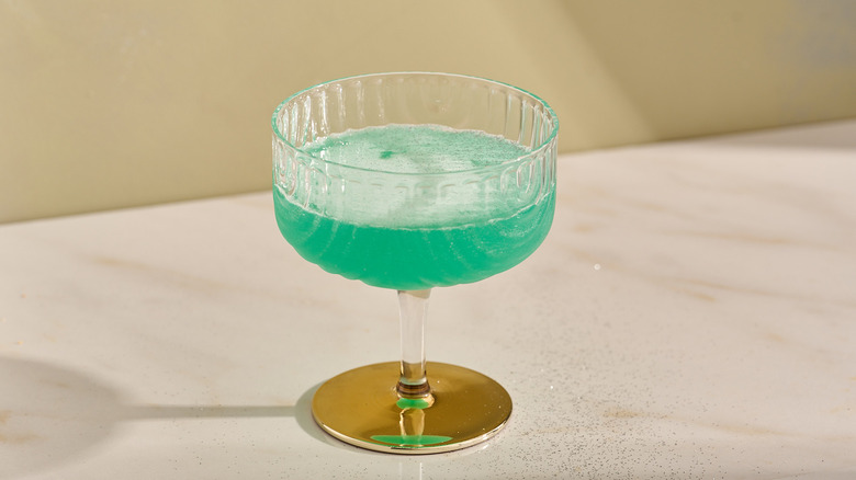 Green Wicked-inspired cocktail on a table