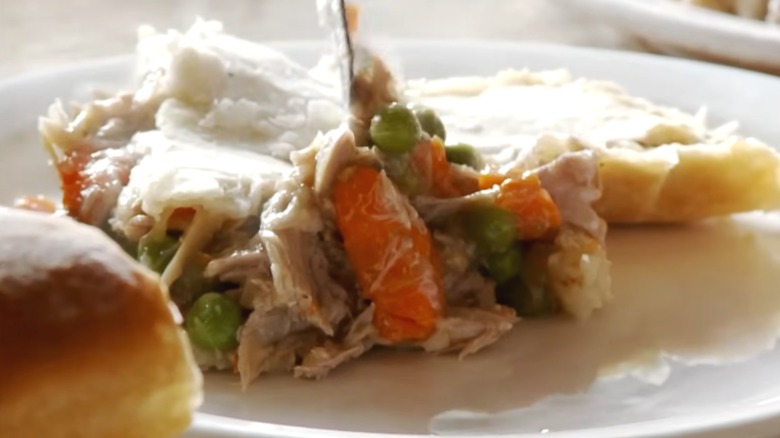 plate with mashed potatoes, carrots, peas and squirrel meat