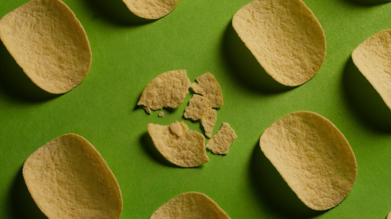 Pringles broken chip green background