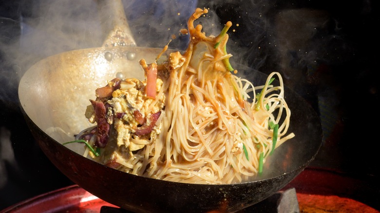 Noodles cooking in wok 