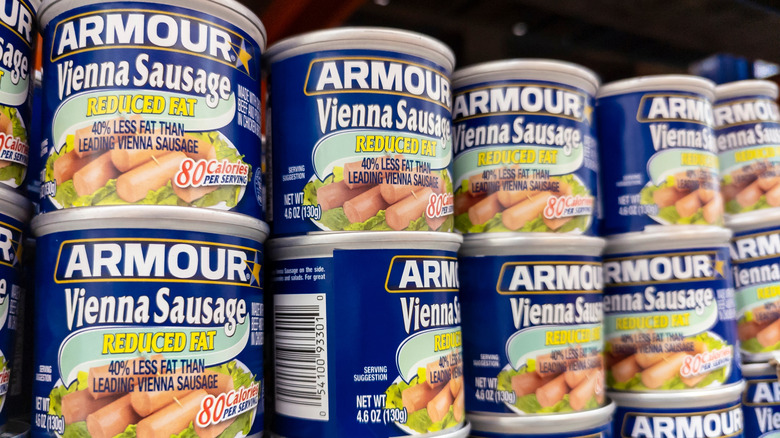 A grocery store shelf of canned Vienna sausage.
