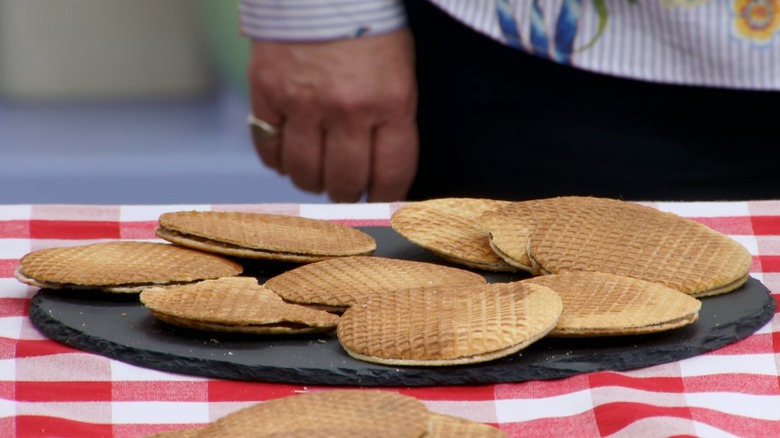 A black plate of warped and somewhat burnt stroopwafels