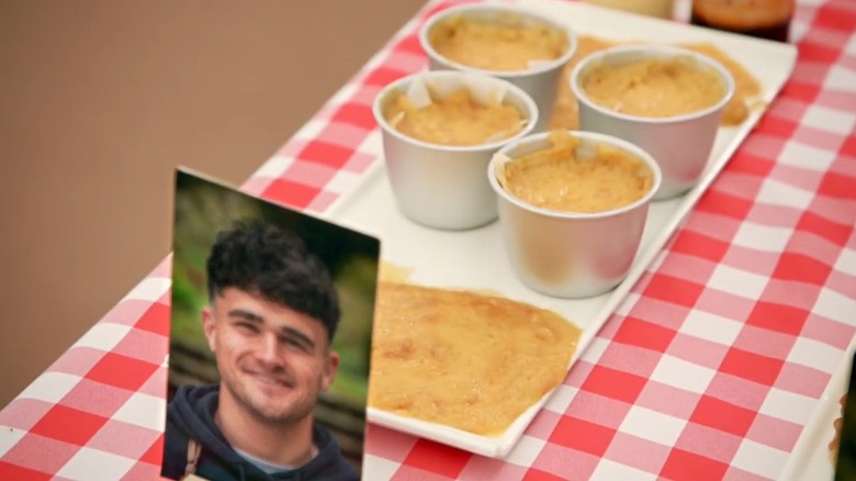 Two piles of yellowish liquid and four metal ramekins still filled with the same liquid