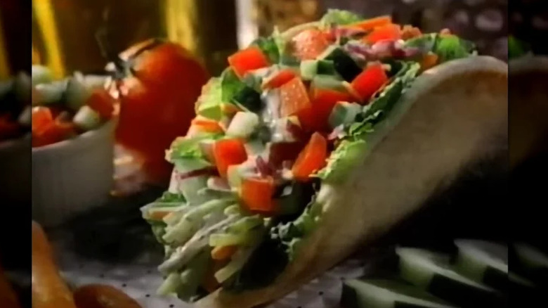 Wendy's pita sandwich filled with lettuce and diced veggies like tomatoes, cucumbers, and onions.