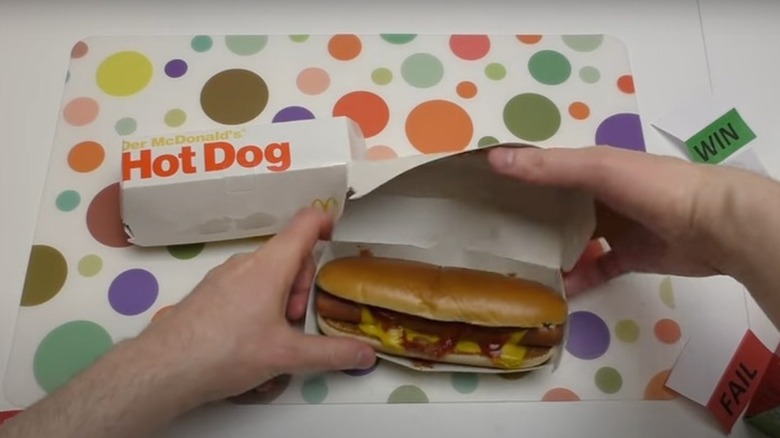 a hot dog with ketchup and mustard in McDonald's packaging.