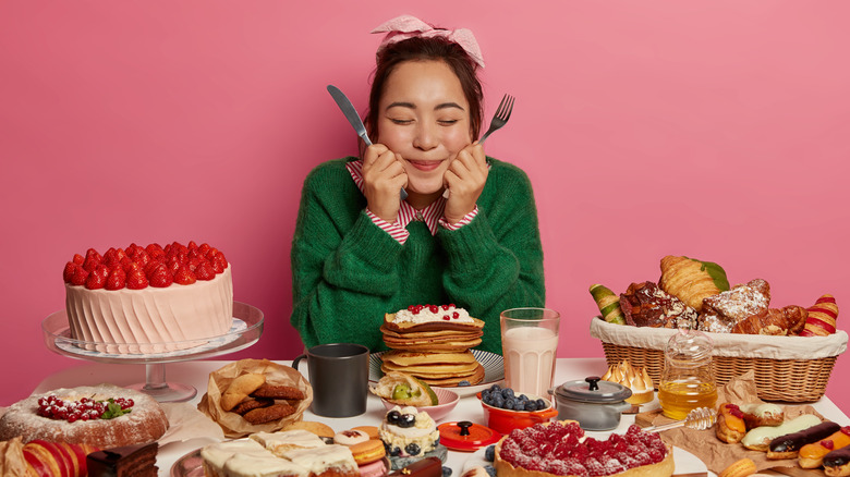 Girl surrounded by pastries