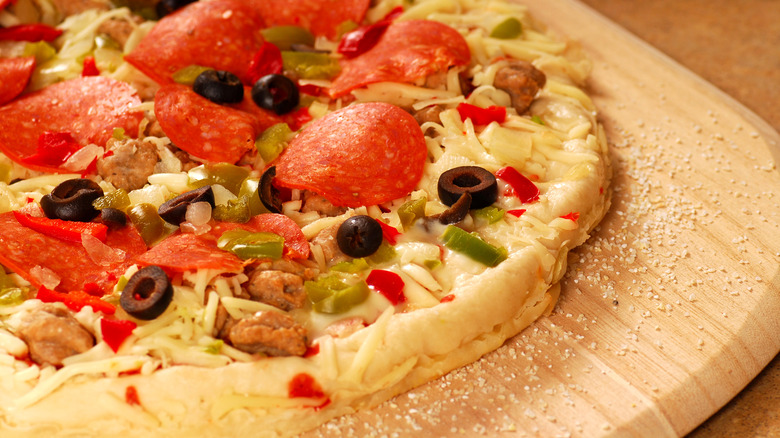 Uncooked pizza on board