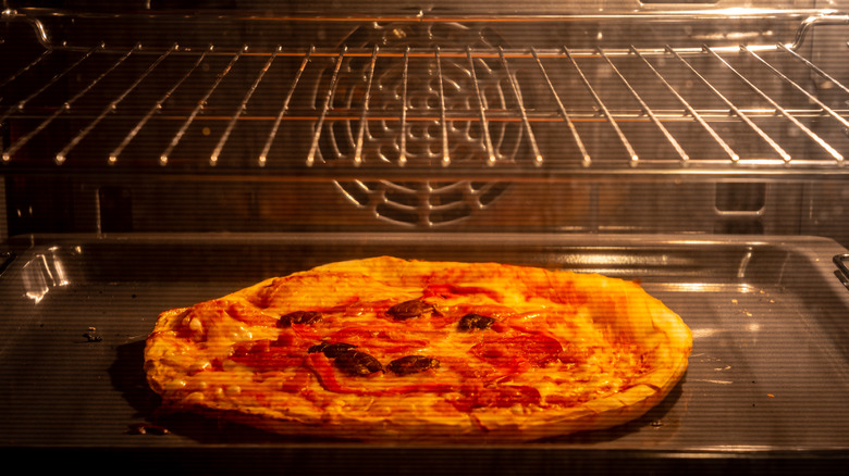 Pizza cooking in oven