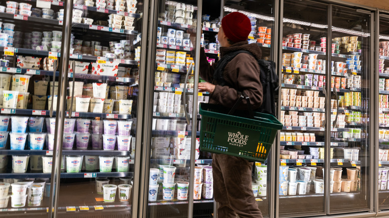 A shopper in the refrigerated aisle of Whole Foods