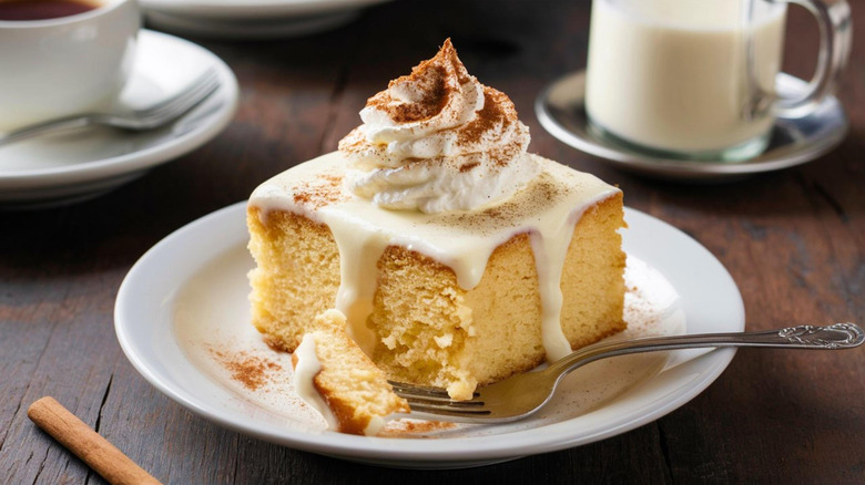 Vanilla pound cake with condensed milk, whipped cream, and cinnamon on top.