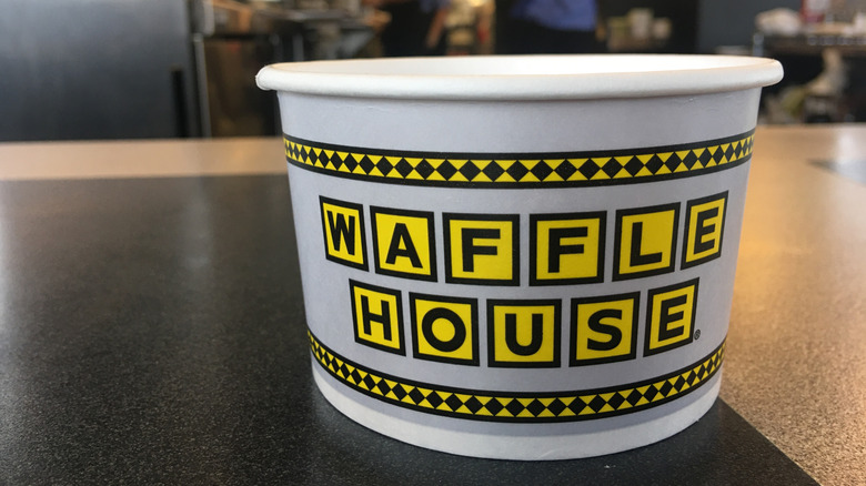 A waffle House cup on a black table inside one of the restaurants