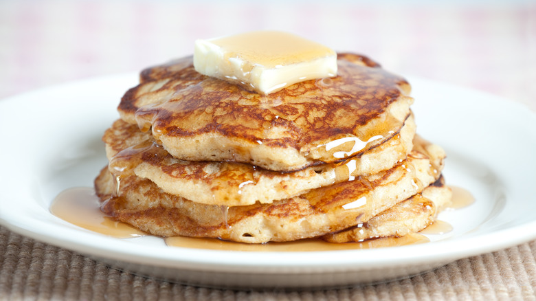 Pancake stack with butter and syrup on a plate