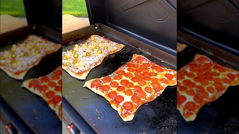 Two pizzas on a Blackstone griddle