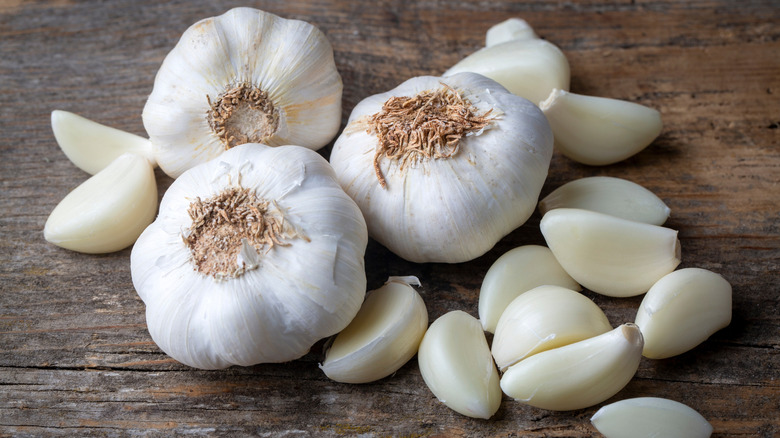 cloves of fresh garlic on rustic wooden table