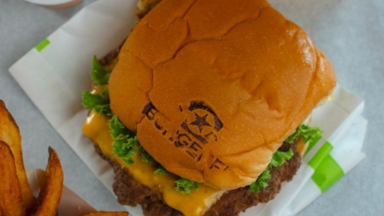Branded burger from BurgerFi with fries